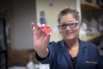 Texas A&M chemist Karen Wooley, holding a Texas-shaped sample of her team's biodegradable natural polymer