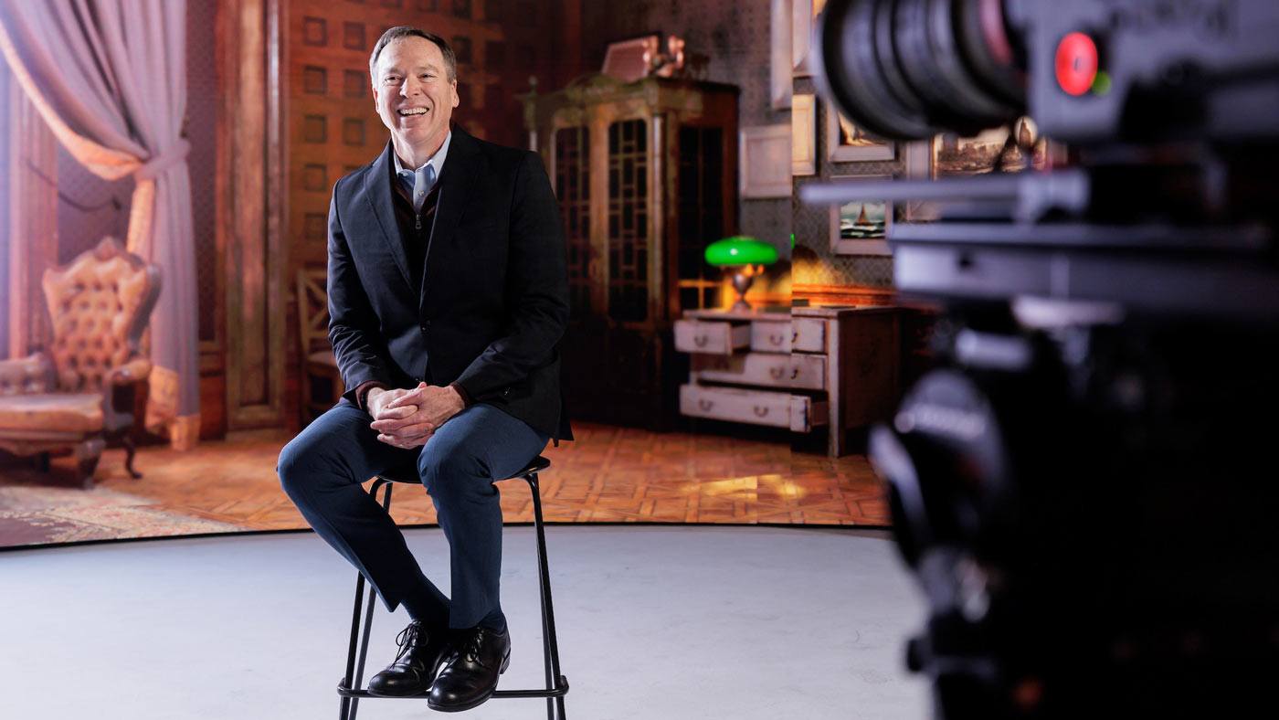 Tim McLaughlin laughs while taking photos on the virtual sound stage