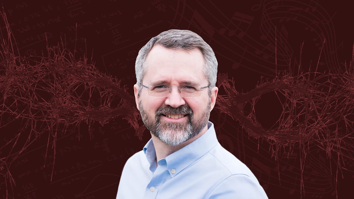 Headshot of Tim Davis over a maroon background