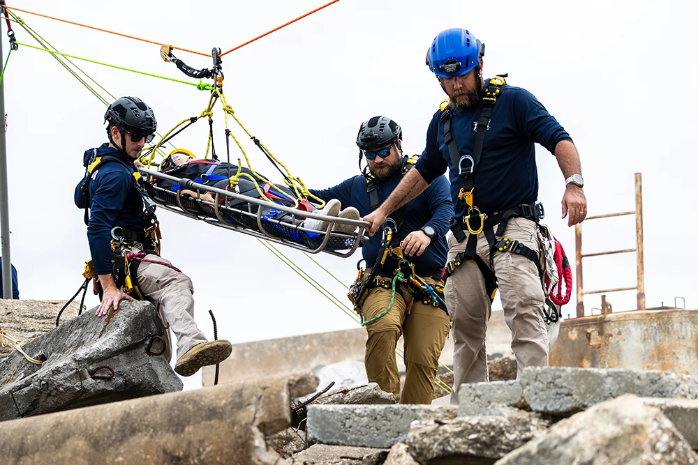 Task Force 1 members practicing using rescue equipment in a simulated disaster scenario
