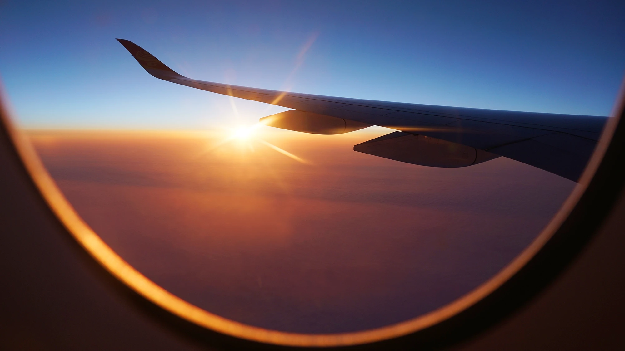 View of a sunset through an airplane window